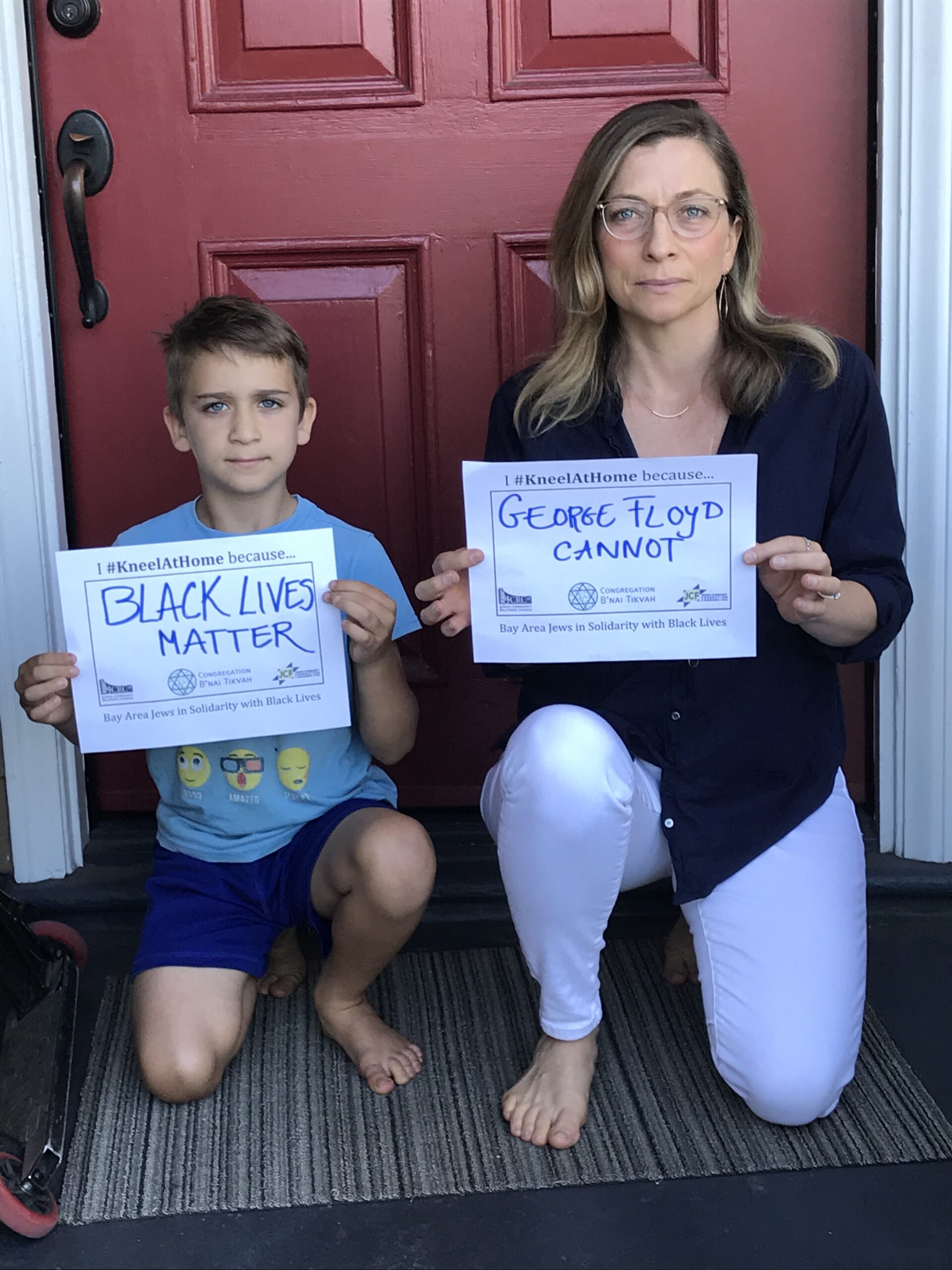 Rabbi and son kneeling for justice